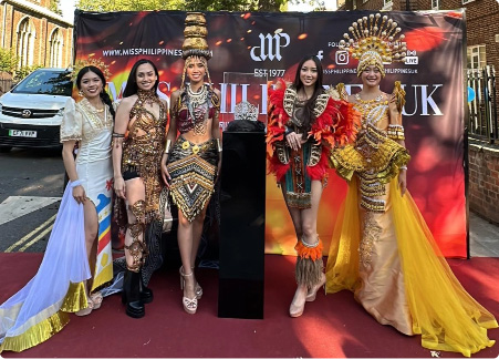 Miss & Mr. Philippines UK contestants in vibrant cultural costumes posing together at the event.