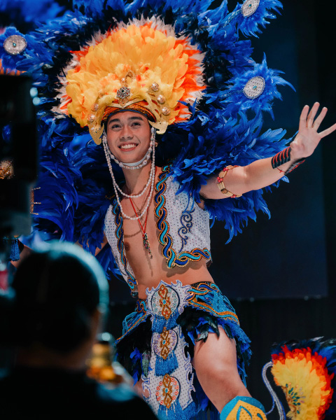 Contestant wearing a vibrant traditional Filipino costume with feathers at Miss & Mr. Philippines UK.