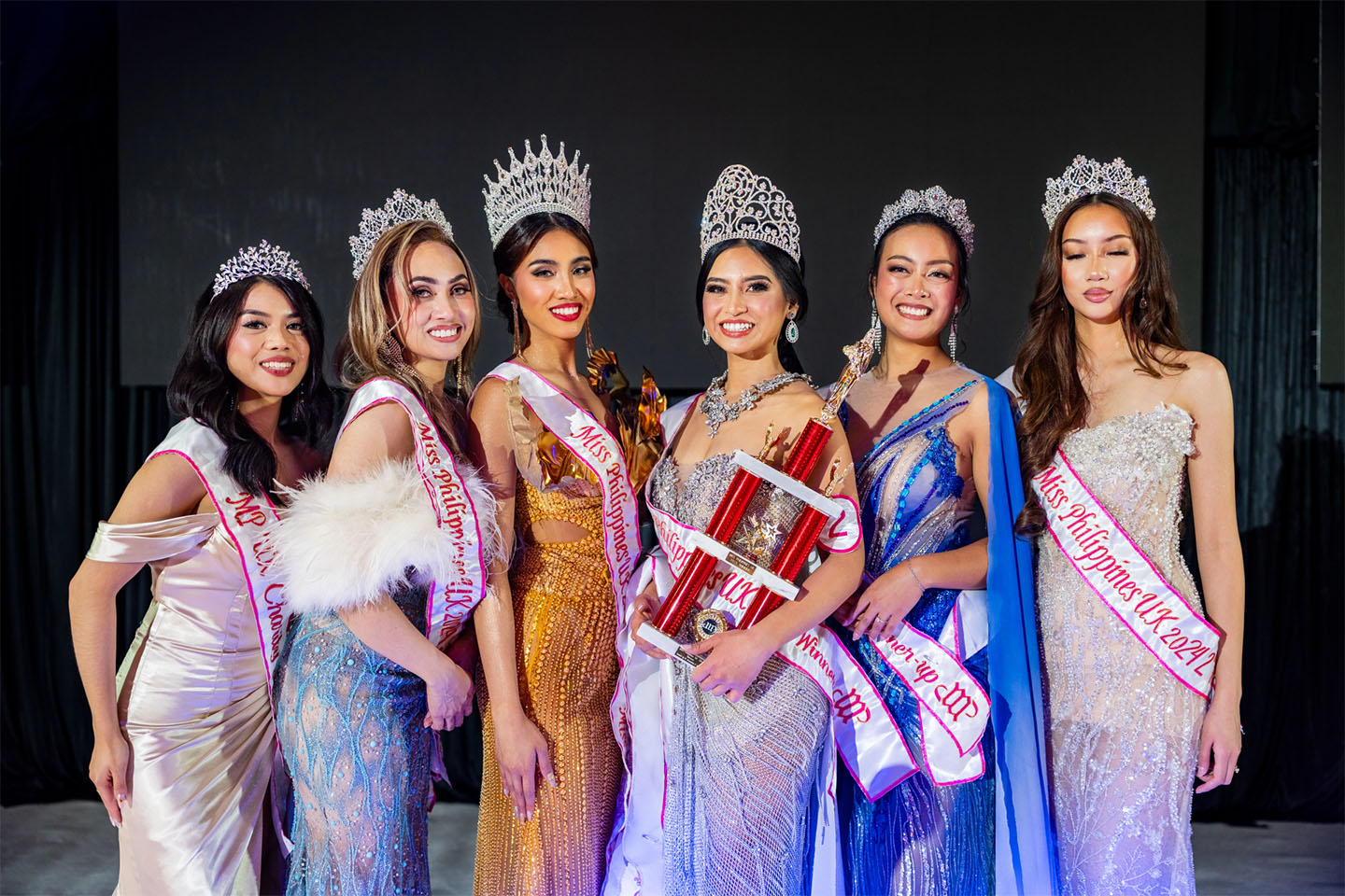 Miss & Mr. Philippines UK contestants with their crowns and sashes, posing together after the pageant.