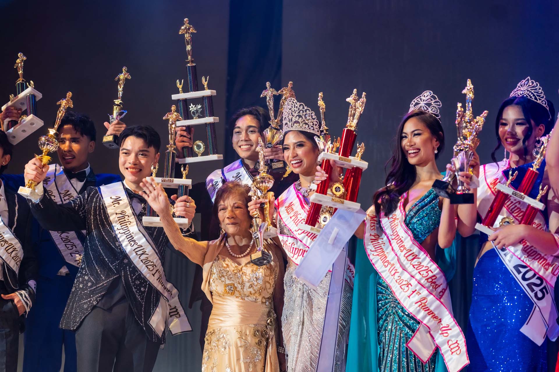 Miss & Mr. Philippines UK 2025 winners holding their trophies with the event organizer.