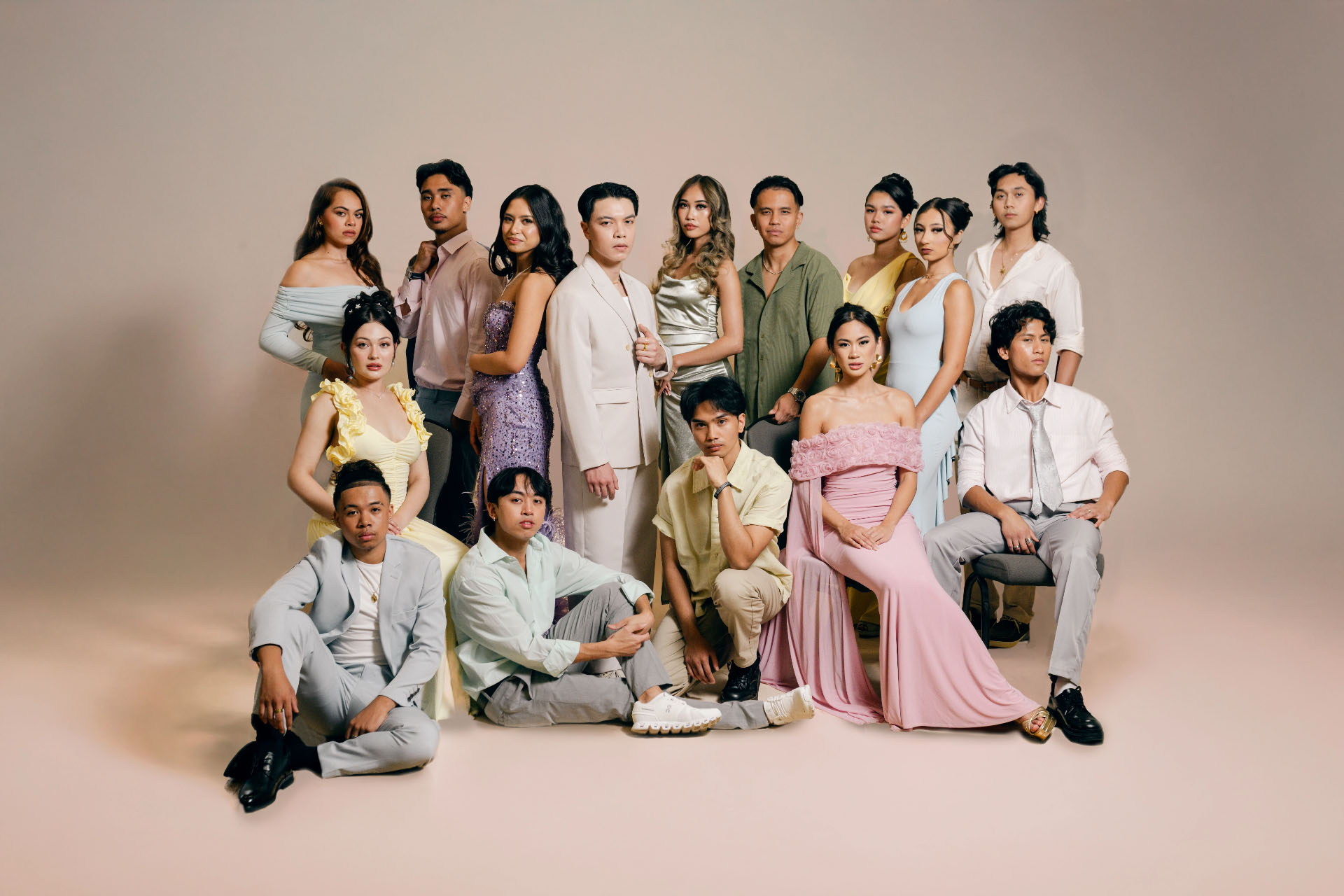 Group photo of individuals in elegant outfits posing together.